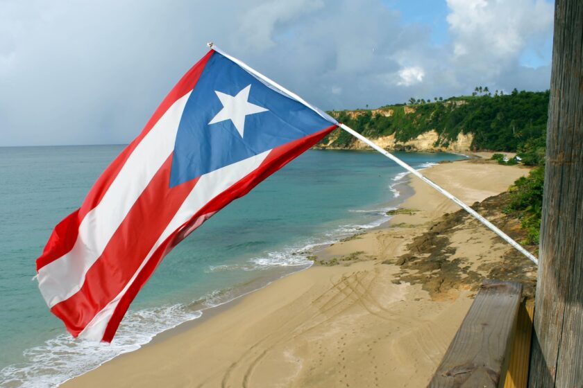 The flag of Puerto Rico nestled on the beach.